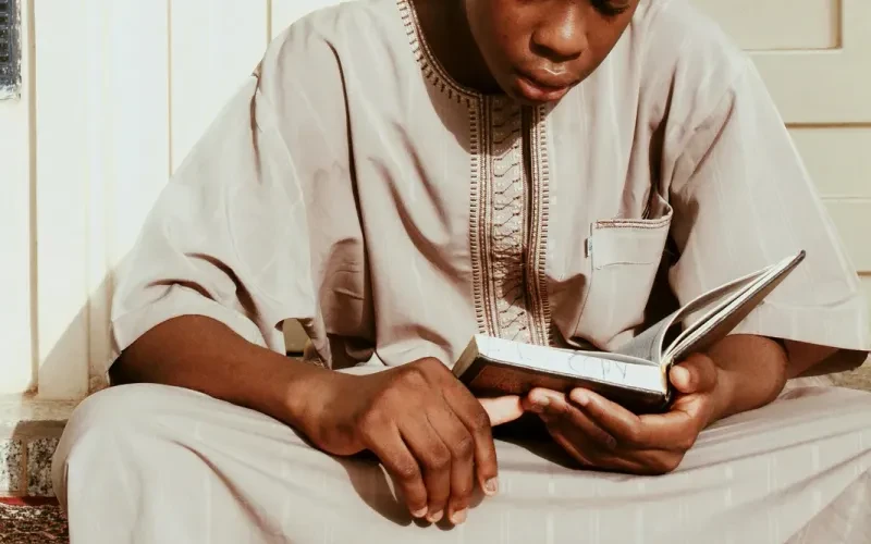 A young student reading from the Qur'an