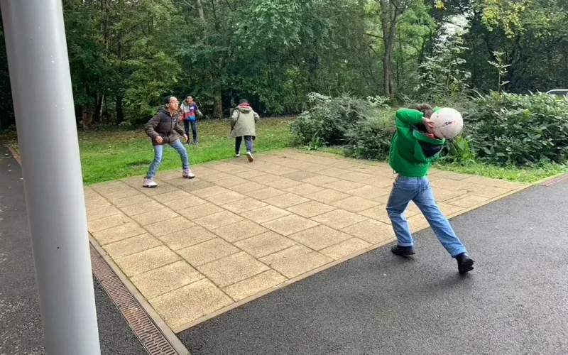 Pupils playing together outdoors at an in-person session