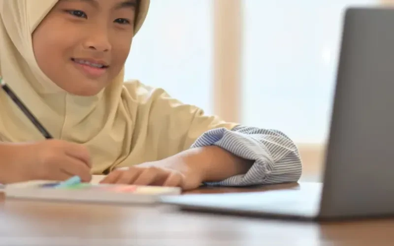 A student working at a laptop during a lesson
