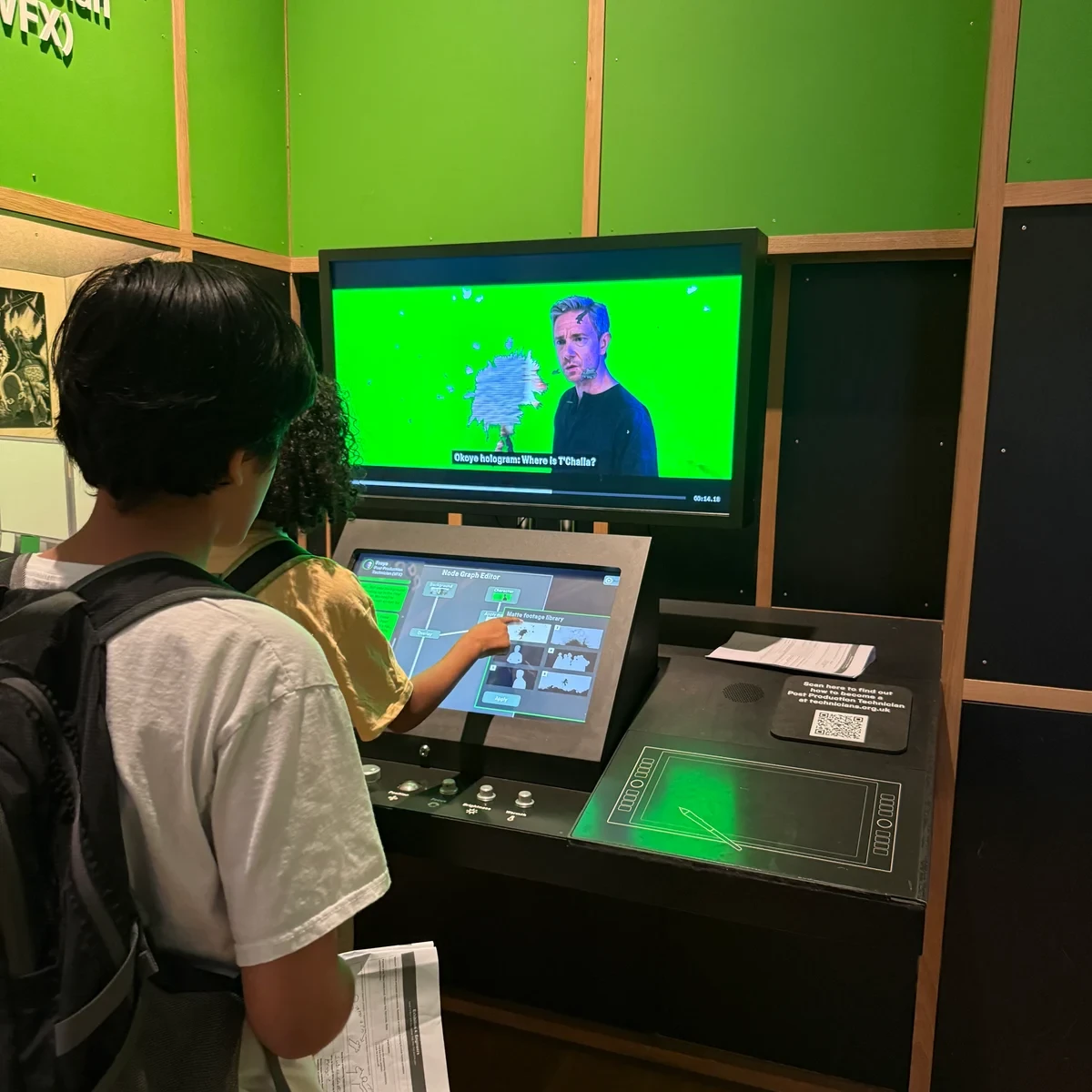 Two pupils using an interactive visual-effects exhibit at a science museum