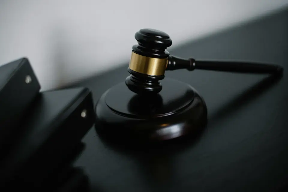 A judge's gavel on a dark desk